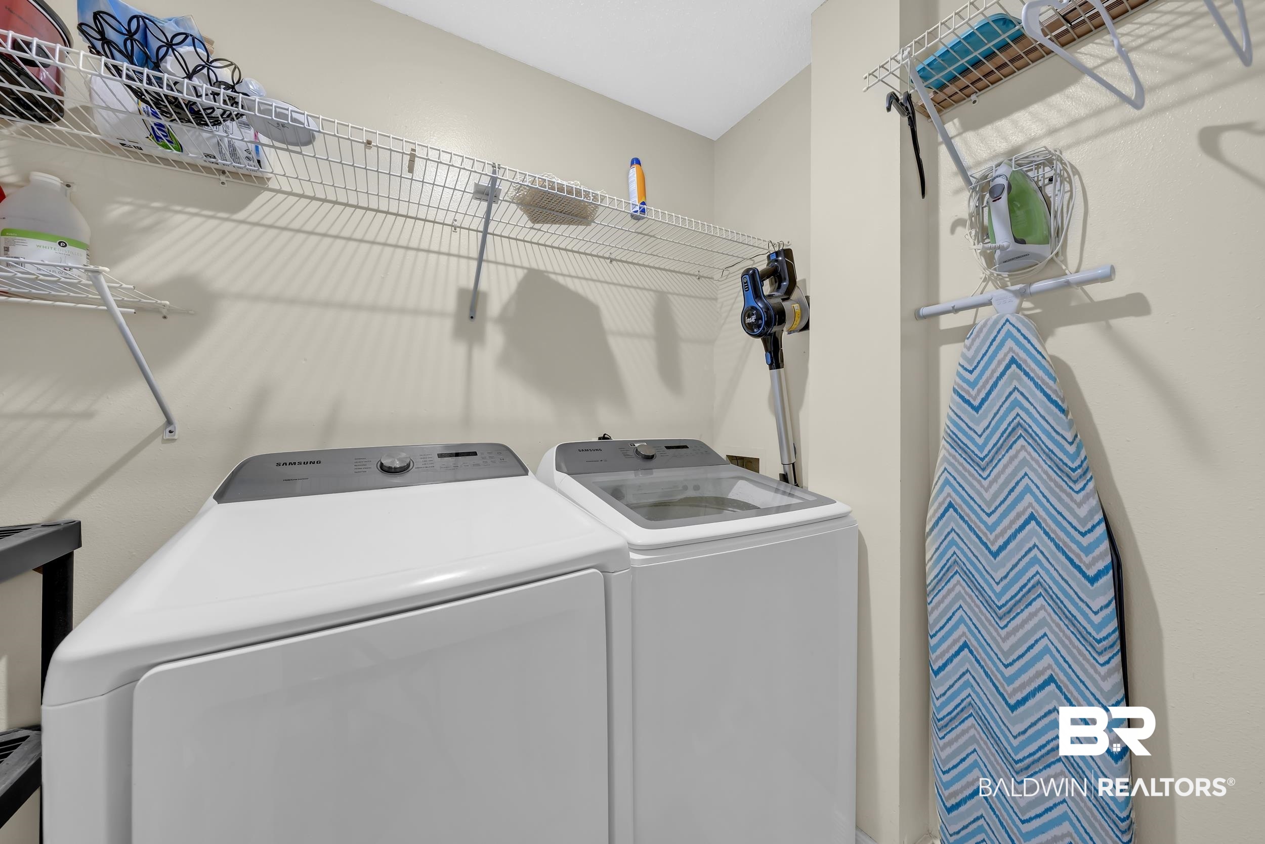 27222 Gulf Road, Unit 33 Orange Beach, AL 36561 - Photo 12 of 29 Dedicated laundry area featuring wire shelving, providing ample storage space