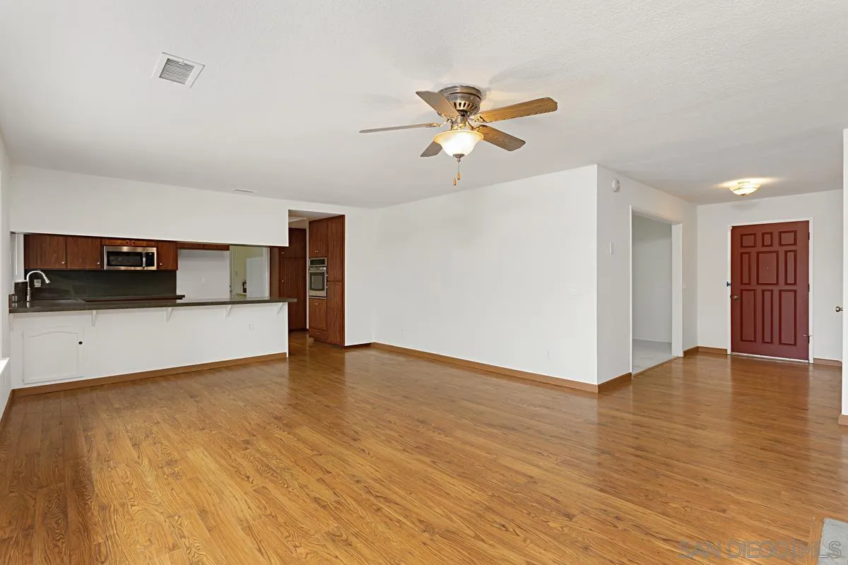 12759 Claire Drive Poway, CA 92064 - Photo 11 of 40 a view of empty room with wooden floor and ceiling fan