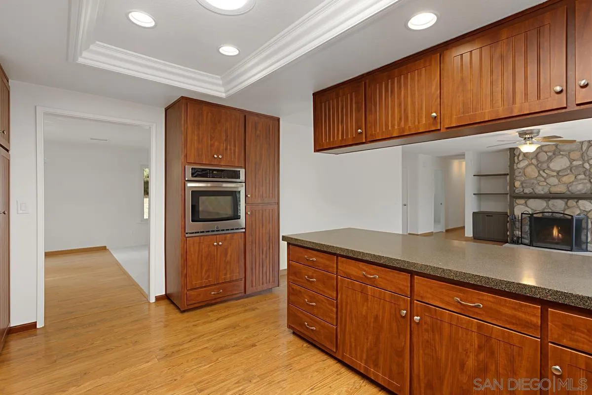12759 Claire Drive Poway, CA 92064 - Photo 17 of 40 a kitchen with granite countertop cabinets and steel stainless steel appliances with cabinets