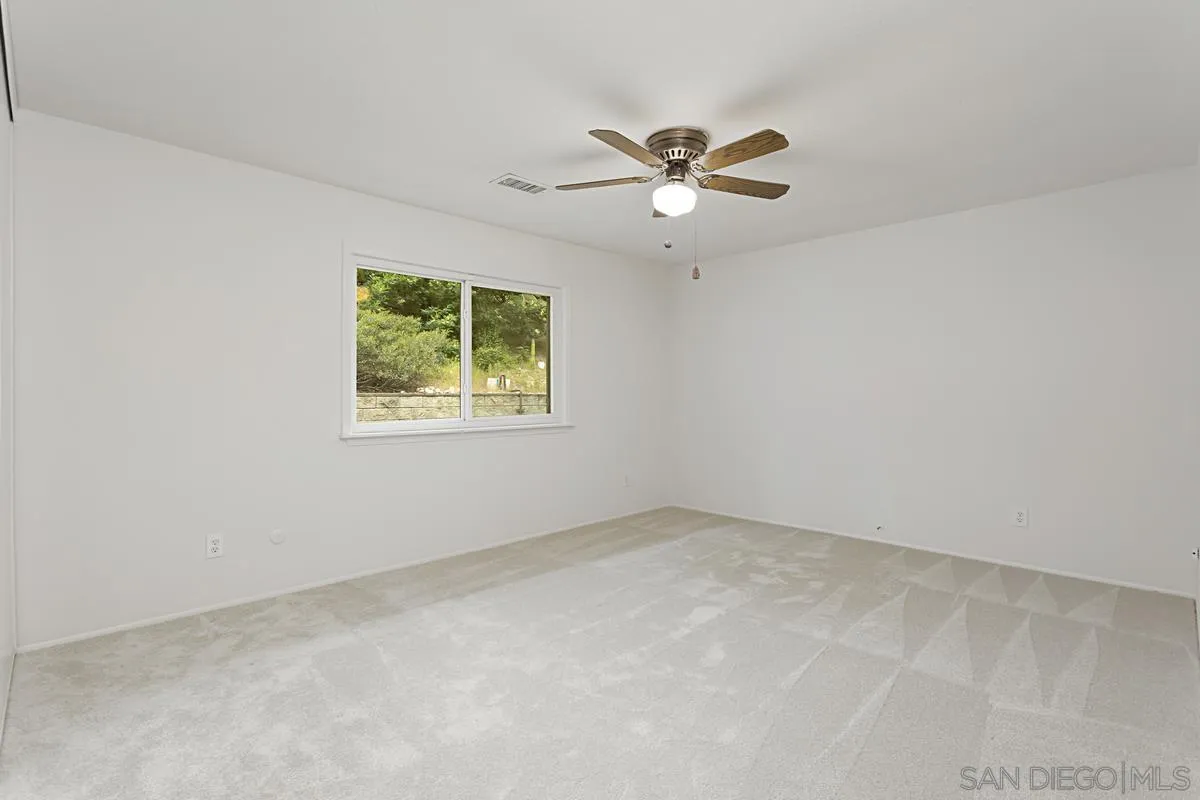 12759 Claire Drive Poway, CA 92064 - Photo 23 of 40 an empty room with windows and fan