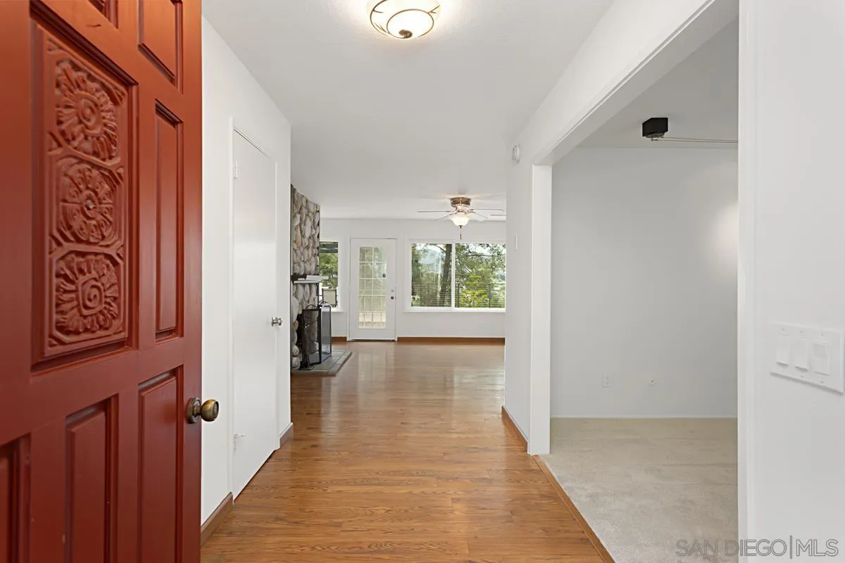 12759 Claire Drive Poway, CA 92064 - Photo 7 of 40 a view of a hallway with wooden floor and windows