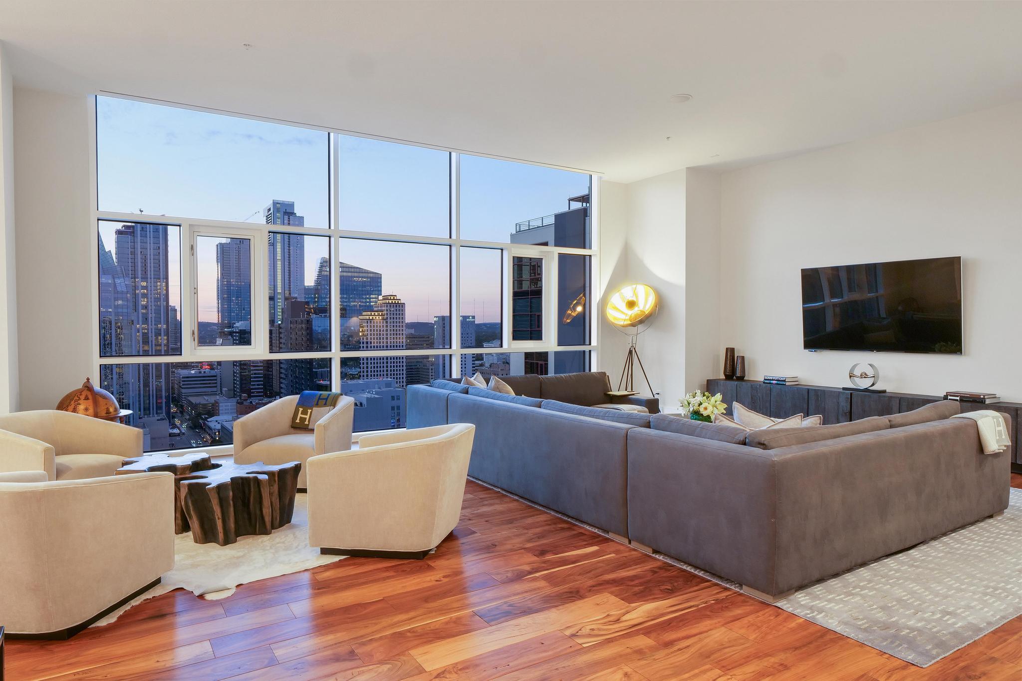 555 East 5th Street, Unit 3022 Austin, TX 78701 - Photo 6 of 40 Living room featuring wood-type flooring and expansive windows