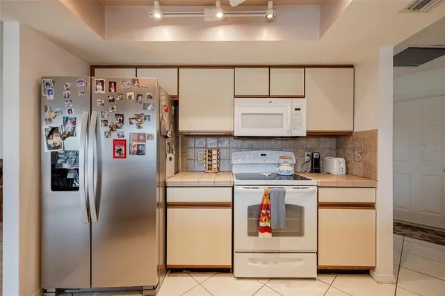 a kitchen with stainless steel appliances a refrigerator and cabinets