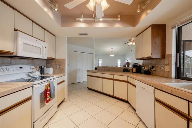 a kitchen with stainless steel appliances granite countertop a sink and cabinets