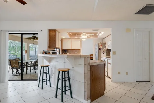 a kitchen with stainless steel appliances kitchen island granite countertop a table and chairs in it
