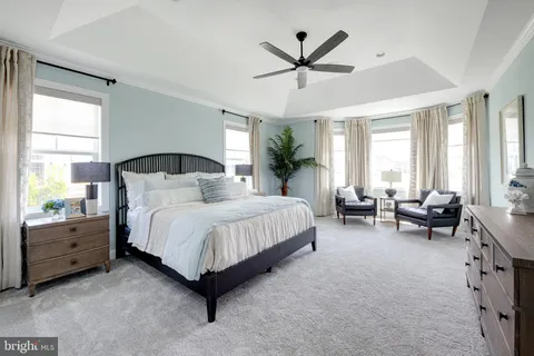 a spacious bedroom with a large bed and a window