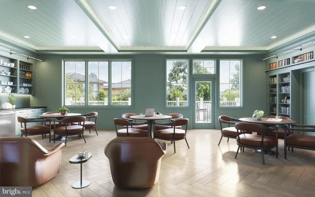 a living room with furniture and large windows