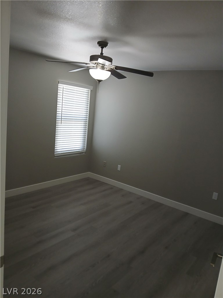 555 East Silverado Ranch Boulevard, Unit 1098 Las Vegas, NV 89183 - Photo 3 of 10 Laminate flooring and a ceiling fan create a comfortable atmosphere in this adaptable room.