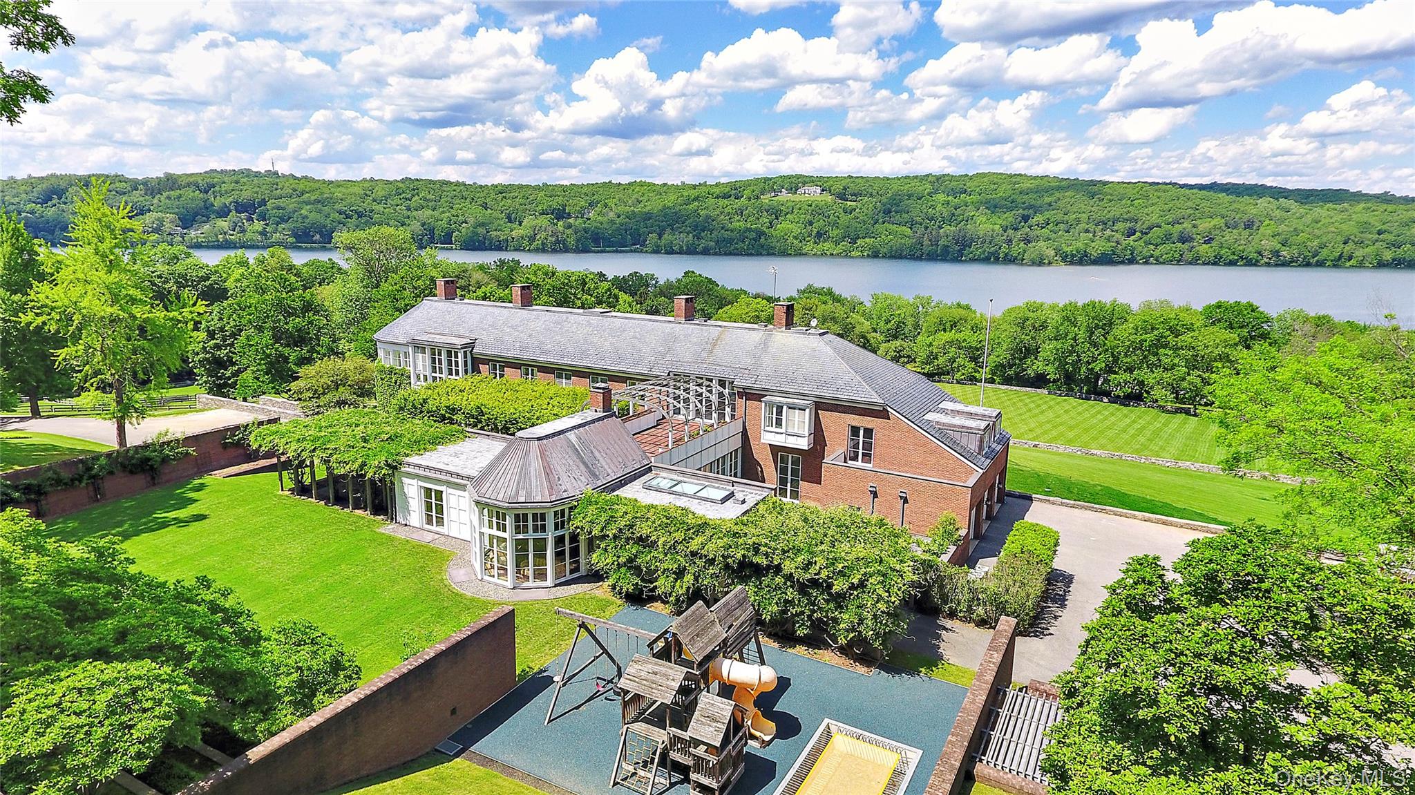 an aerial view of a house with outdoor space and lake view