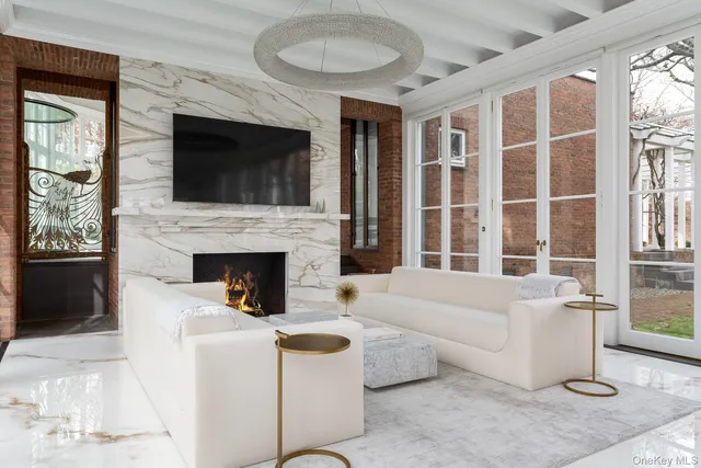 a living room with furniture a flat screen tv and a fireplace
