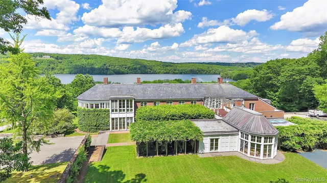 an aerial view of a house with swimming pool and garden