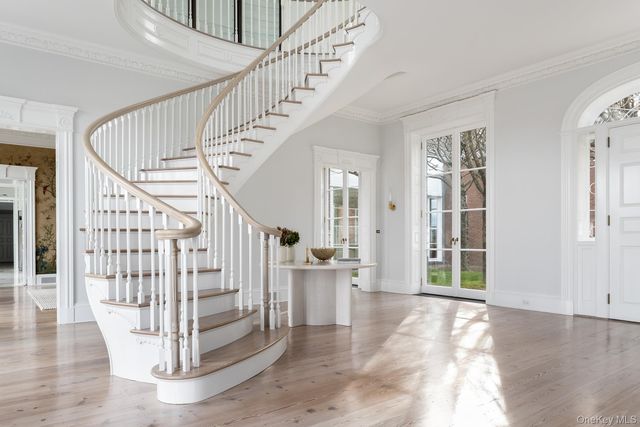 a view of entryway and hall with wooden floor