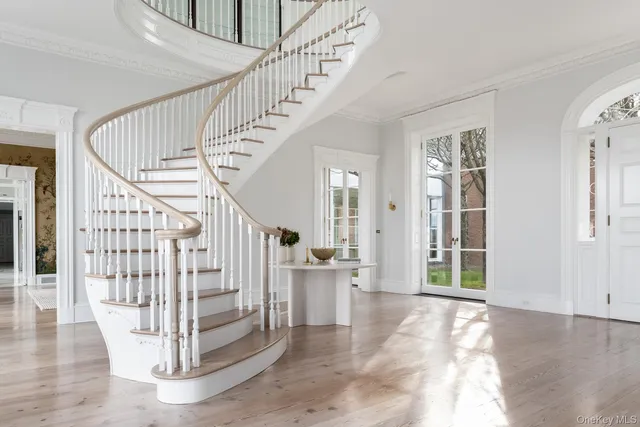 a view of entryway and hall with wooden floor