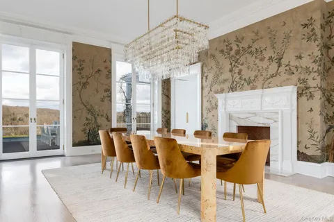 a dining room with furniture a chandelier and a fireplace