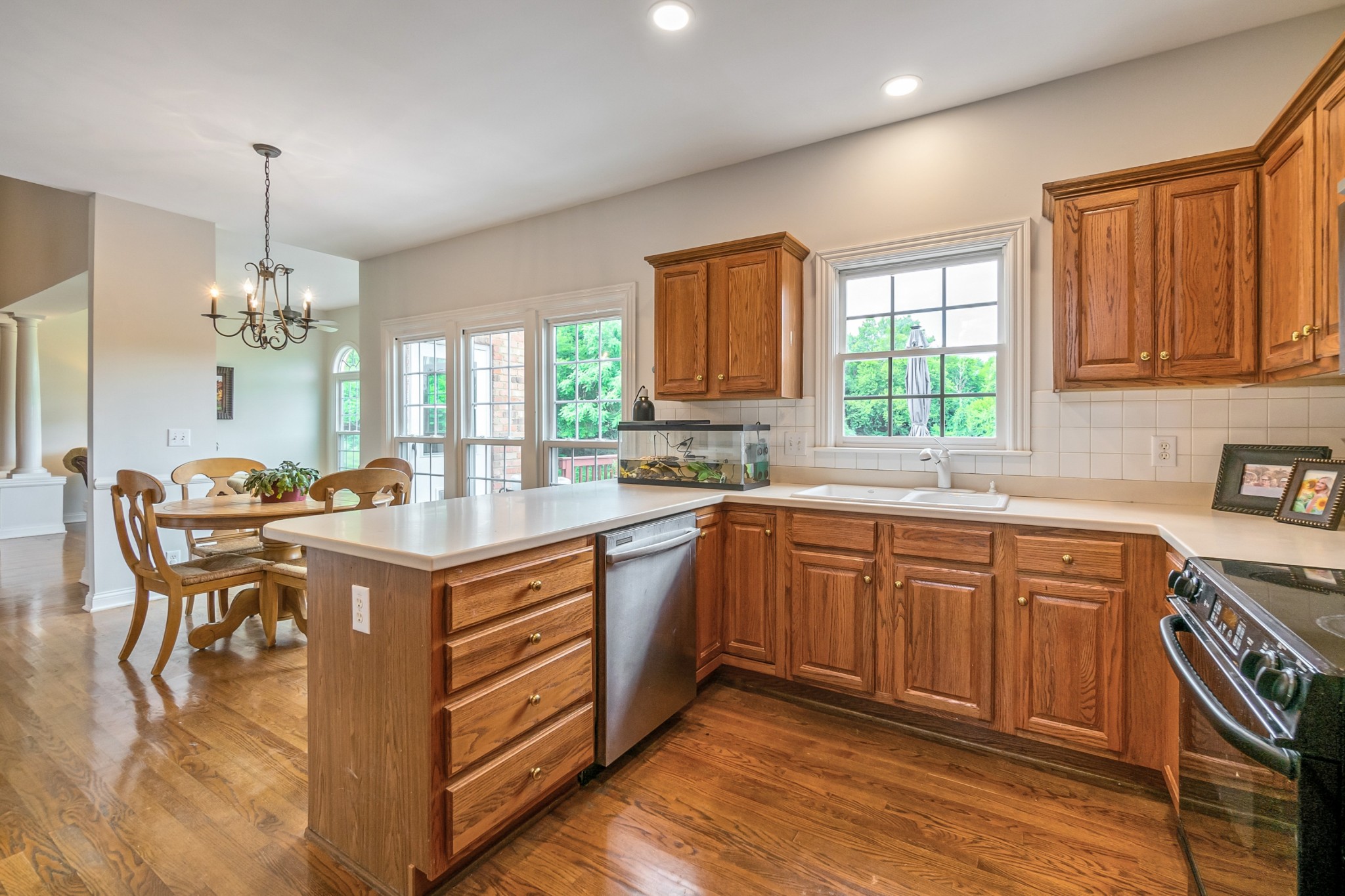 413 Doe Ridge Franklin, TN 37067 - Photo 13 of 42 a kitchen with kitchen island granite countertop a sink window and cabinets