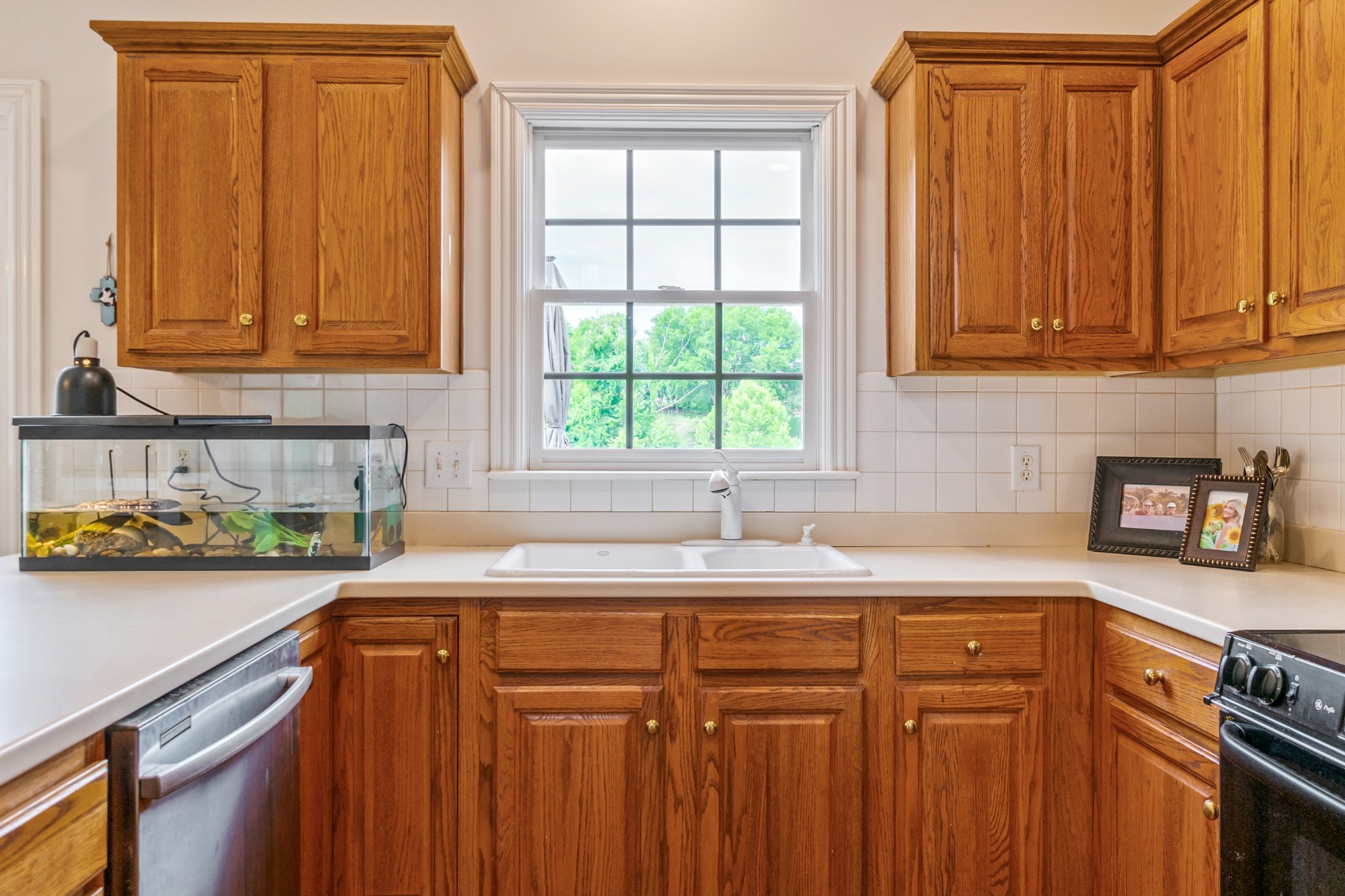 413 Doe Ridge Franklin, TN 37067 - Photo 14 of 42 a kitchen with stainless steel appliances granite countertop a sink a stove cabinets and a window