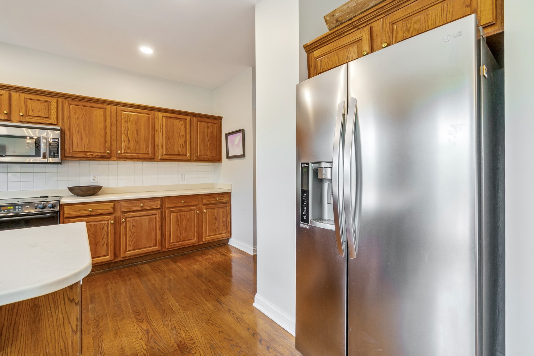 413 Doe Ridge Franklin, TN 37067 - Photo 15 of 42 a kitchen with stainless steel appliances granite countertop a refrigerator and a stove top oven