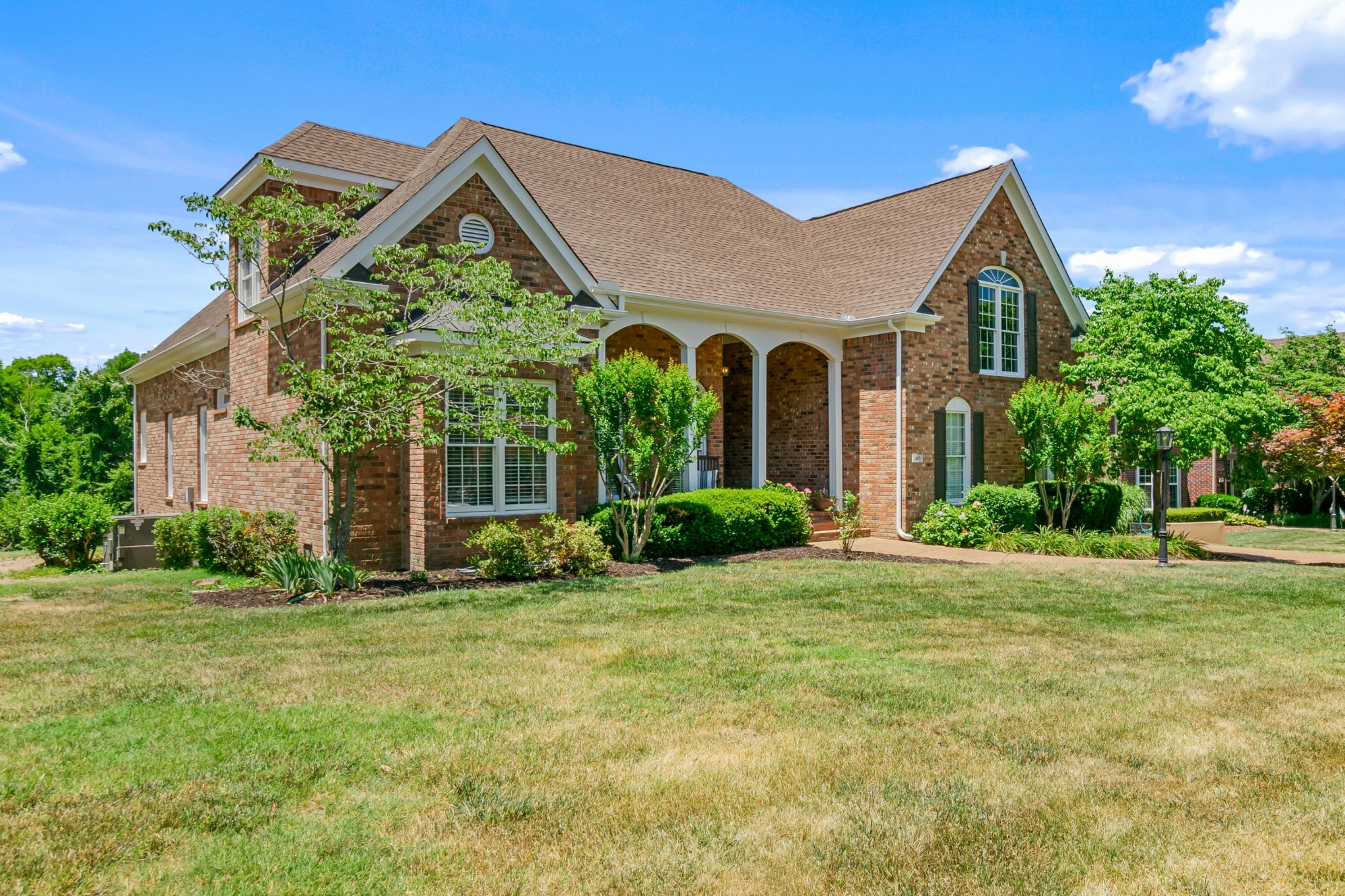 413 Doe Ridge Franklin, TN 37067 - Photo 2 of 42 a front view of a house with garden