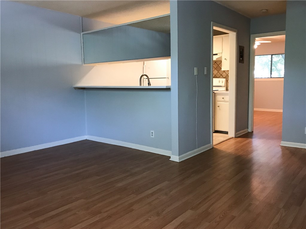 5001 Bull Creek Road, Unit 116 Austin, TX 78731 - Photo 4 of 6 a view of a room with wooden floor and windows