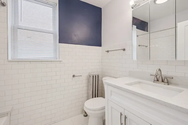 a bathroom with a sink a toilet and a mirror
