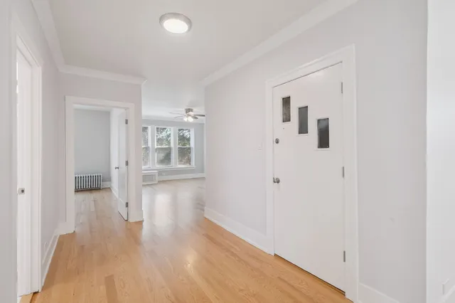 a view of a hallway with wooden floor