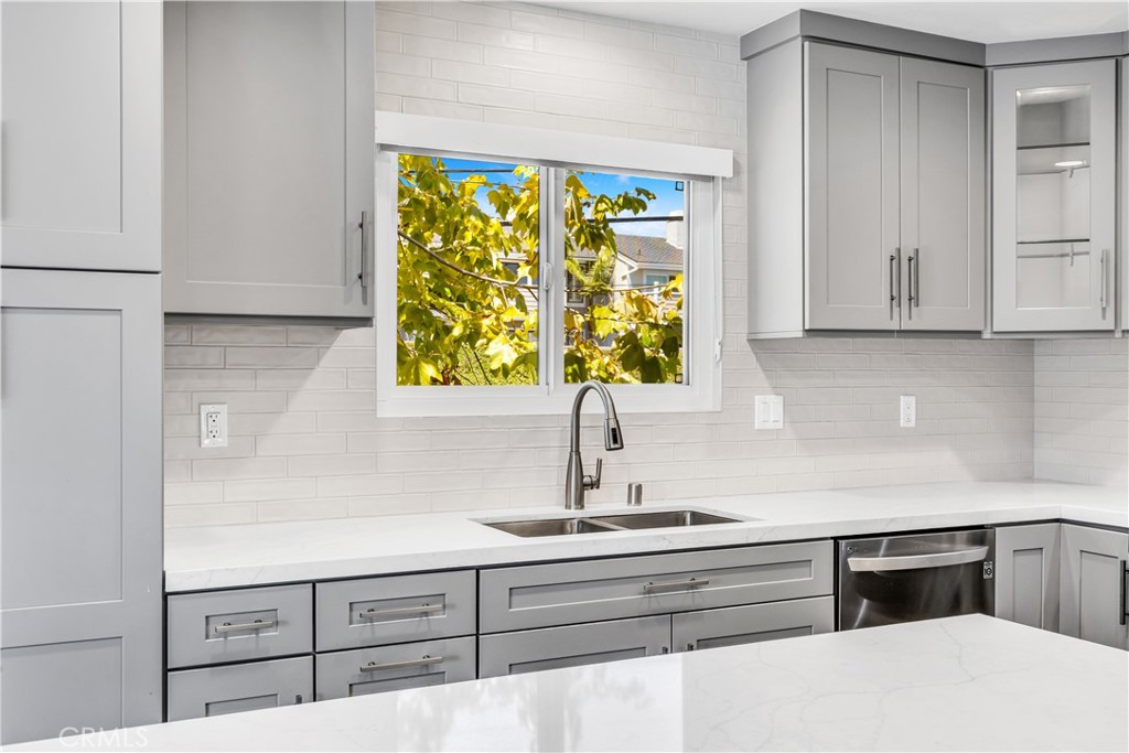 24502 Selva Road, Unit A2 Dana Point, CA 92629 - Photo 12 of 23 a kitchen with stainless steel appliances white cabinets and a sink