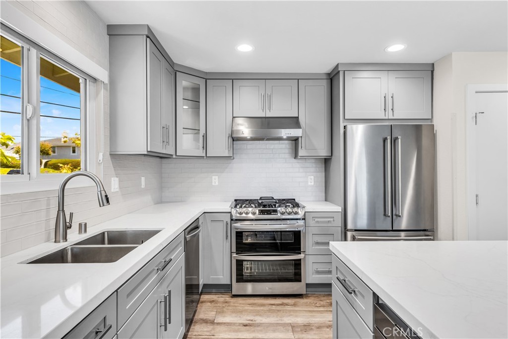 24502 Selva Road, Unit A2 Dana Point, CA 92629 - Photo 14 of 23 a kitchen that has a sink stainless steel appliances and cabinets