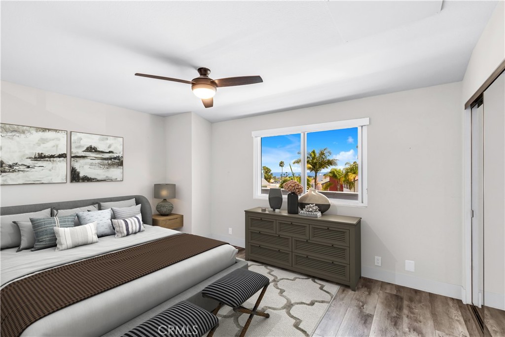 24502 Selva Road, Unit A2 Dana Point, CA 92629 - Photo 16 of 23 a bedroom with a bed and a chandelier