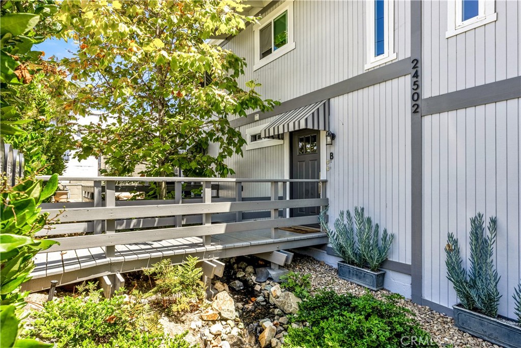 24502 Selva Road, Unit A2 Dana Point, CA 92629 - Photo 2 of 23 a view of a house with pool and wooden fence