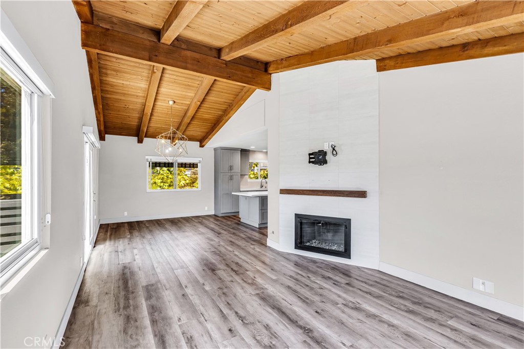 24502 Selva Road, Unit A2 Dana Point, CA 92629 - Photo 3 of 23 a view of an empty room with a fireplace and a window