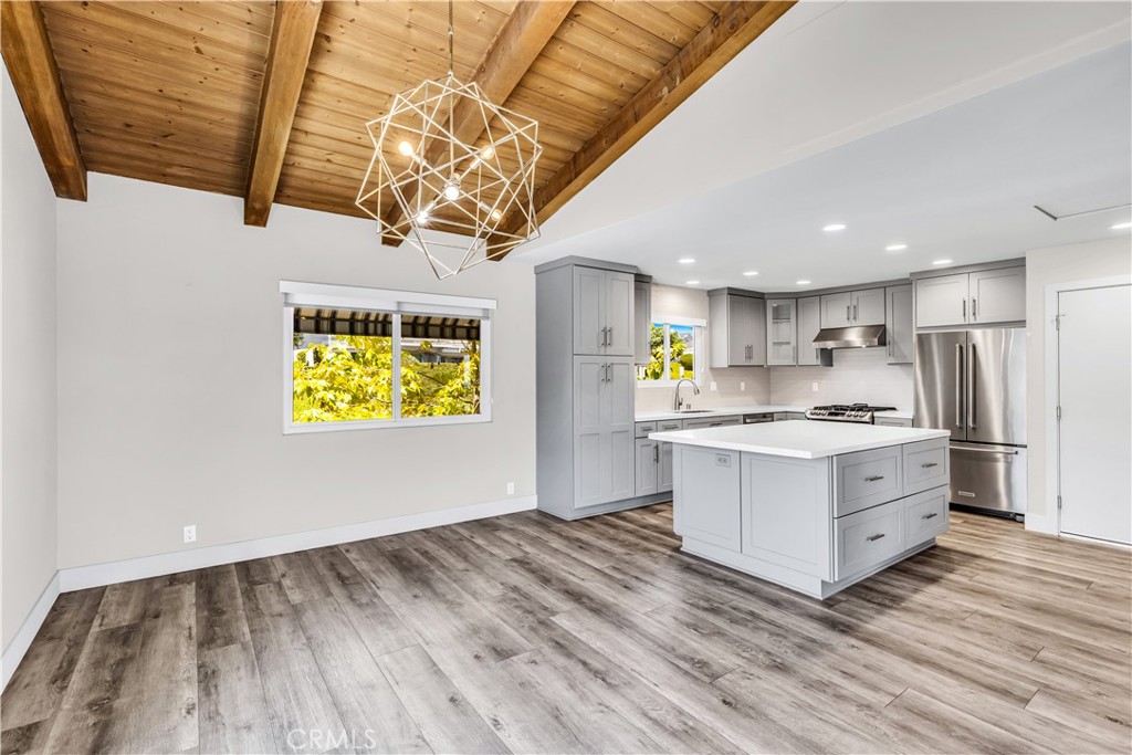 24502 Selva Road, Unit A2 Dana Point, CA 92629 - Photo 5 of 23 a kitchen with stainless steel appliances granite countertop a stove a sink and a microwave