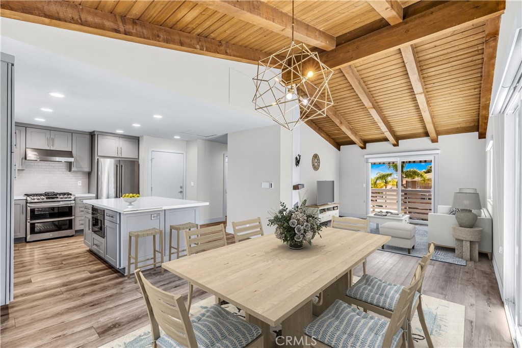 24502 Selva Road, Unit A2 Dana Point, CA 92629 - Photo 9 of 23 a living room with stainless steel appliances kitchen island granite countertop furniture and wooden floor