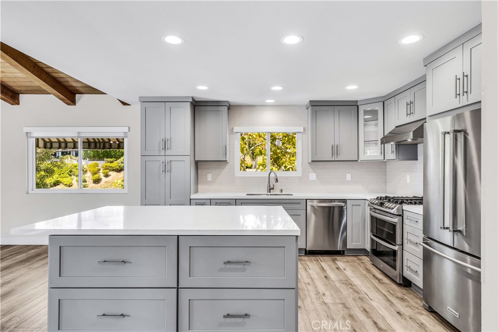 24502 Selva Road, Unit A2 Dana Point, CA 92629 - Photo 10 of 23 a kitchen with stainless steel appliances granite countertop a sink and a stove