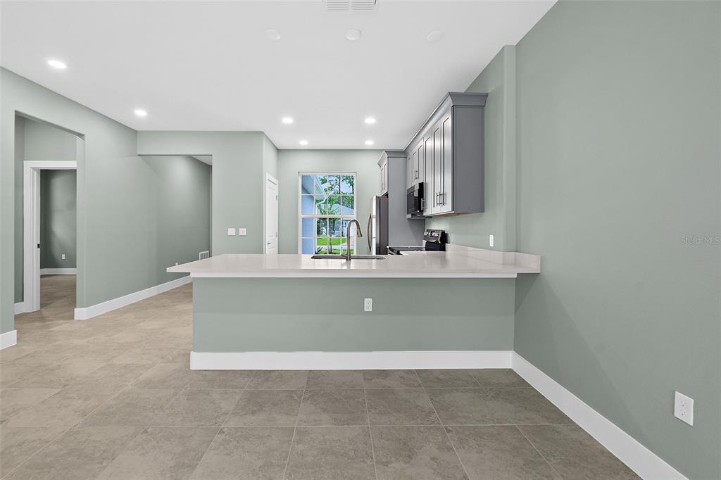 13 Karas Trail Palm Coast, FL 32164 - Photo 13 of 37 a bathroom with a sink a mirror and a window