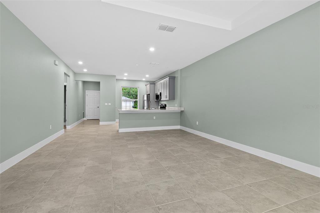 13 Karas Trail Palm Coast, FL 32164 - Photo 16 of 37 a view of a big room with wooden cabinet and windows