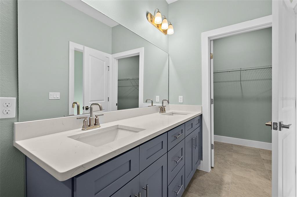 13 Karas Trail Palm Coast, FL 32164 - Photo 24 of 37 a bathroom with a sink double vanity and a mirror