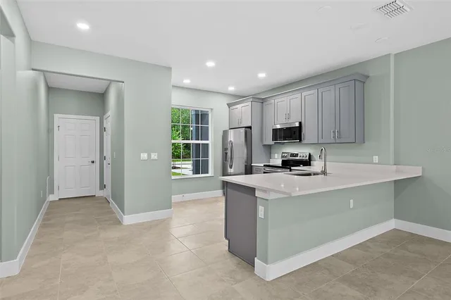 a kitchen with a cabinets and white appliances