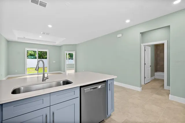 a kitchen with stainless steel appliances granite countertop a stove a refrigerator and a microwave