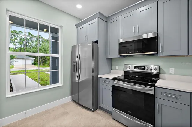 a kitchen with cabinets sink and stainless steel appliances