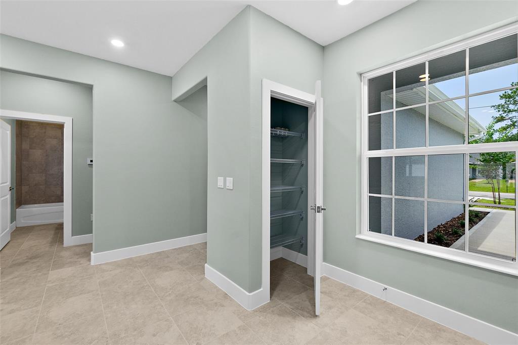 13 Karas Trail Palm Coast, FL 32164 - Photo 10 of 37 a view of an empty room with wooden floor and a window