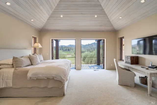 an outdoor sitting area with furniture and garden view