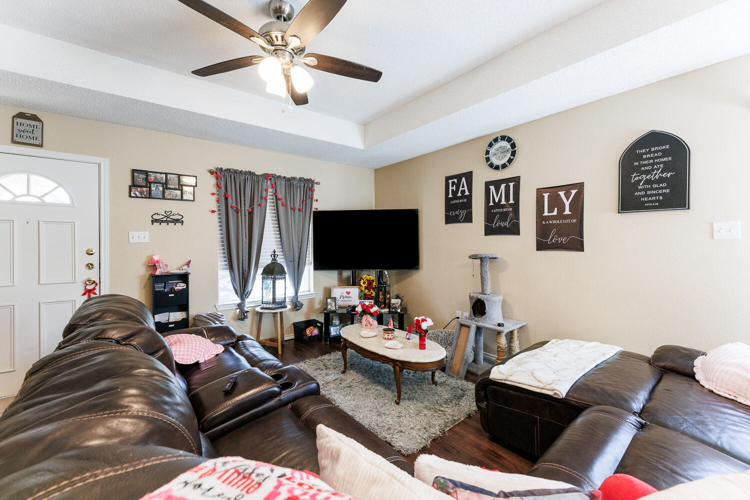 3416 97th Street Lubbock, TX 79423 - Photo 6 of 14 a living room with furniture and a flat screen tv