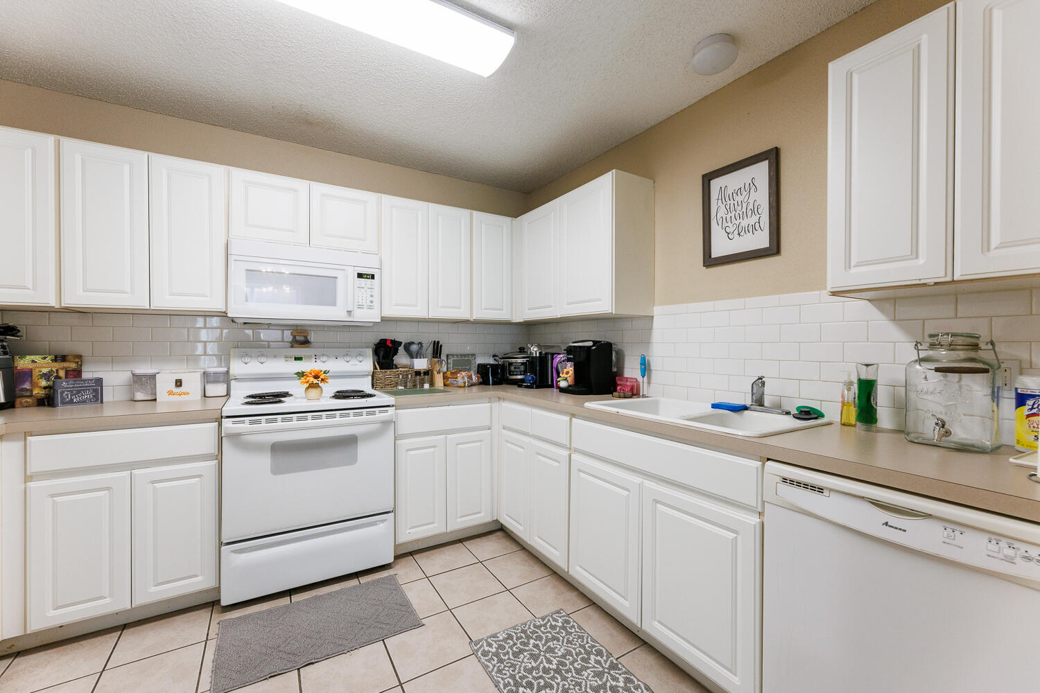 3416 97th Street Lubbock, TX 79423 - Photo 10 of 14 a kitchen with cabinets appliances a sink and a counter top