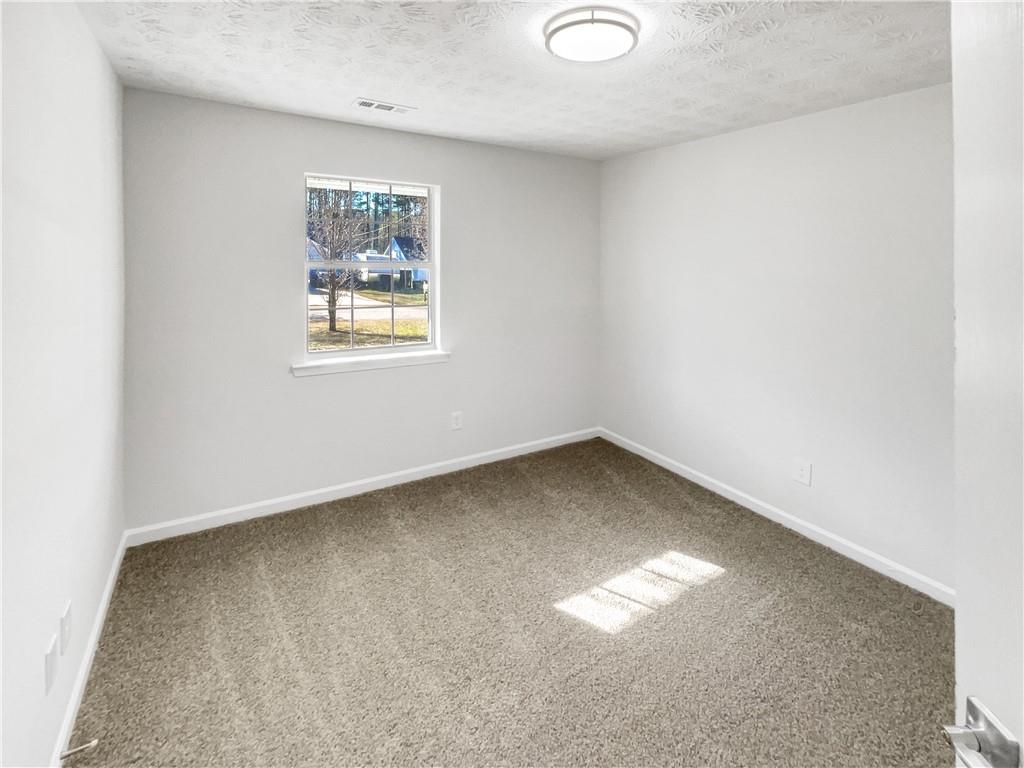 24 Chelsea Lane Grantville, GA 30220 - Photo 12 of 20 an empty room with a window