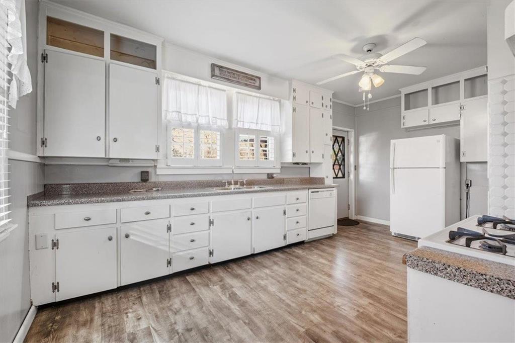 1 Poplar Street Northeast Rome, GA 30161 - Photo 14 of 28 a kitchen with granite countertop white cabinets and white appliances
