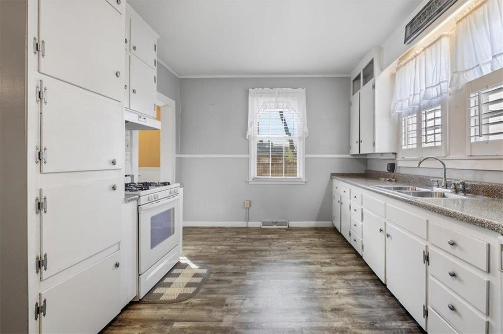 1 Poplar Street Northeast Rome, GA 30161 - Photo 16 of 28 a kitchen with granite countertop a sink stove and refrigerator