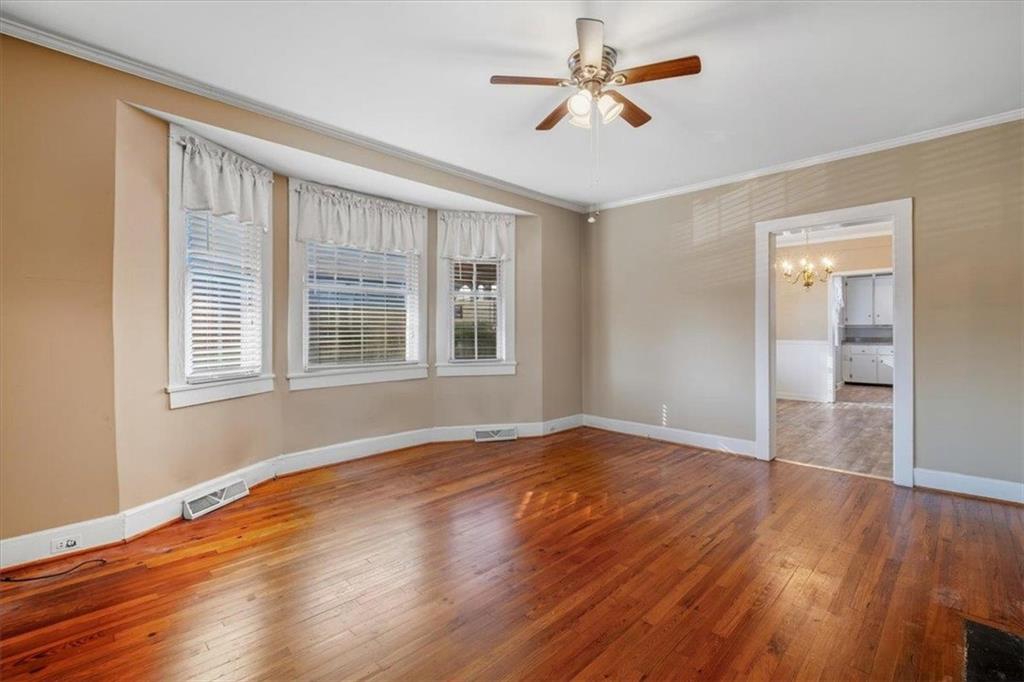 1 Poplar Street Northeast Rome, GA 30161 - Photo 9 of 28 a view of empty room with wooden floor and fan