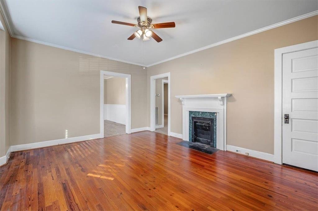 1 Poplar Street Northeast Rome, GA 30161 - Photo 10 of 28 a view of empty room with wooden floor and fireplace