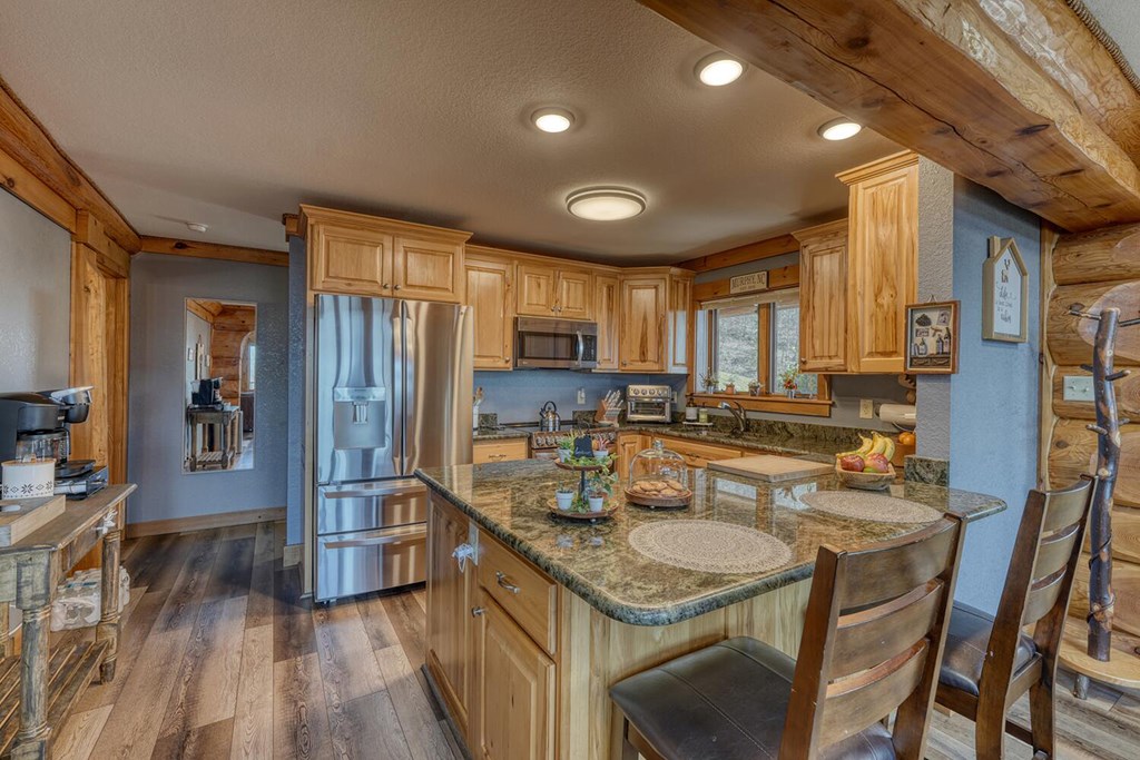 103 Wisteria Drive Murphy, NC 28906 - Photo 13 of 62 a kitchen with refrigerator a sink dishwasher and wooden cabinets with wooden floor
