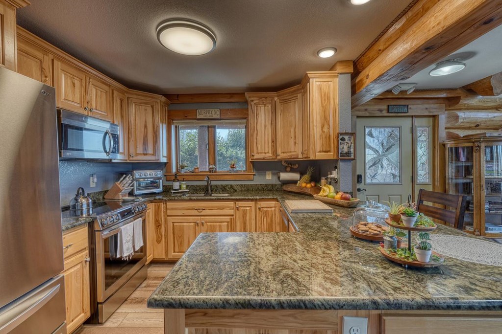 103 Wisteria Drive Murphy, NC 28906 - Photo 14 of 62 a kitchen with sink refrigerator and cabinets